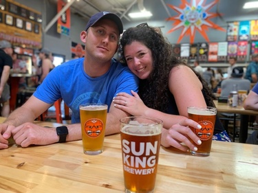 Celebrating right after their engagement at Sun King Brewery
