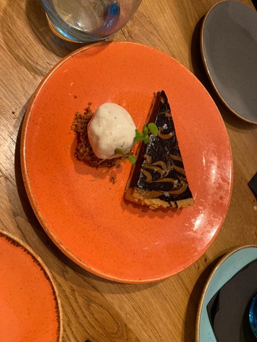 Salted caramel chocolate tart, amaretto ice cream & nougat praline