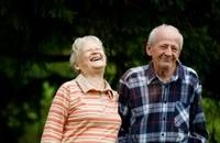 An elderly couple on a joyful walk.