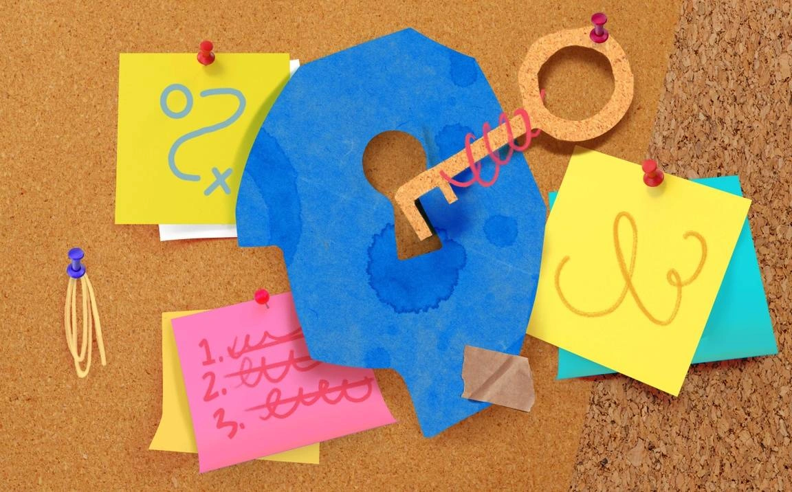 A series of different shaped and colored Post-Its are attached to a cork board with tacks, along with a key.
