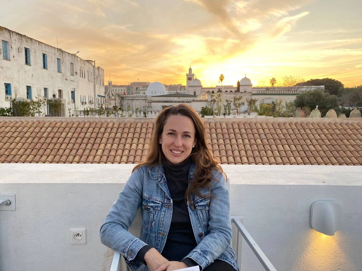 Michelle LeMeur, Idealist Grad School Fair success story, sitting outside in Italy.