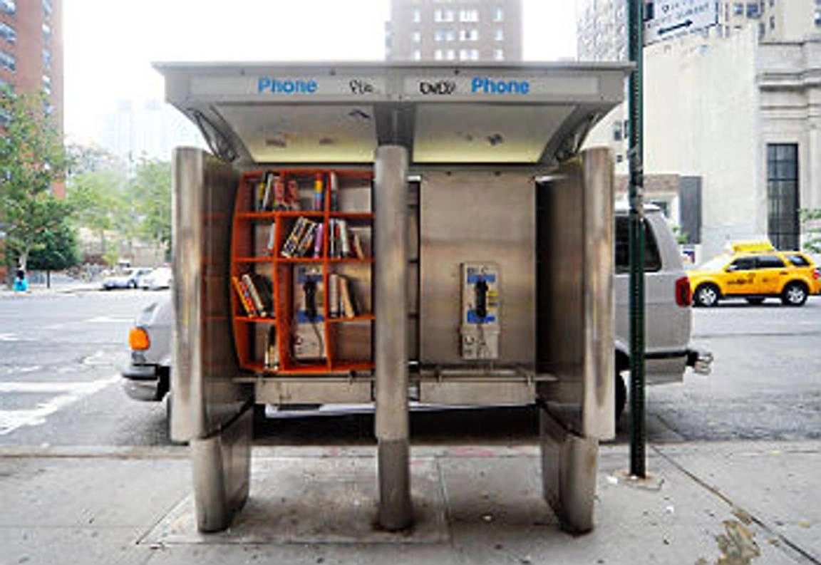 Books in a telephone booth.
