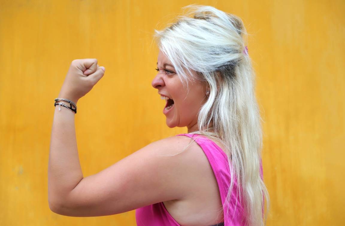 A young woman expressing happiness and achievement