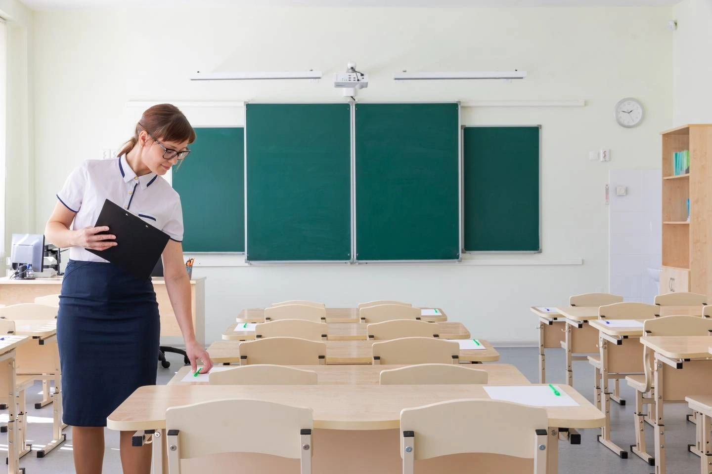 Teacher standing in a classroom.