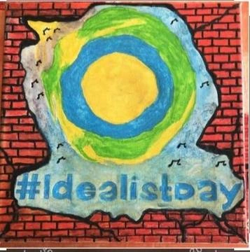 A painting of the Idealist logo on a brick wall.