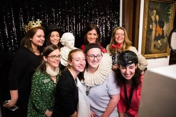 Folger Development team taking a photo booth picture with a william shakespeare bust and other props at donor event
