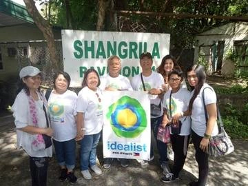 Group outside holding the Idealist logo