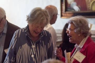 two older women patrons laughing at the Folger's Tea Party