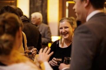 woman staff member smiling in group at Folger event