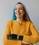 woman with prosthetic arm in yellow sweater smiling