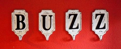 Coat hooks that spell out the word, "Buzz."