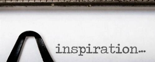 A typewriter with 'inspiration...' written on it.