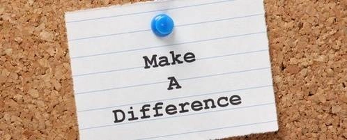A note on a cork board that says, "Make a difference."