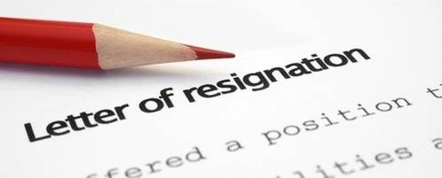 A letter of resignation with a red pencil on it.