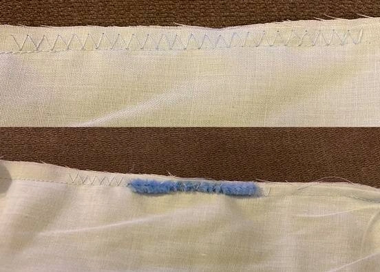 Two separate pieces of fabric with hemmed edges.