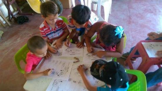 group of children learning in a classroom.