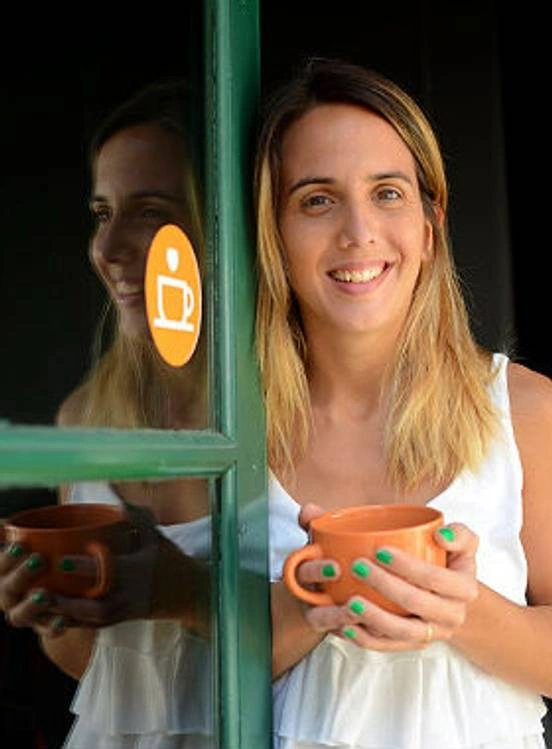 Woman holding an orange mug.