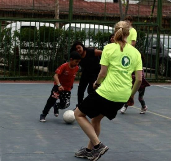 Group of people and children playing soccer