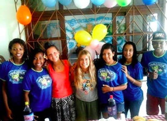 A group of people smiling with balloons.