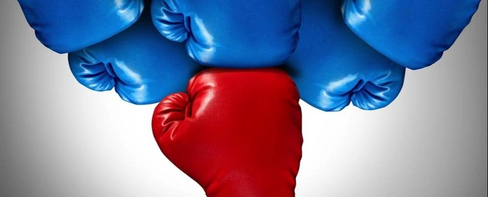 A red boxing glove punching multiple blue boxing gloves.