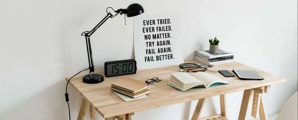 A work desk with an inspirational quote in the center.