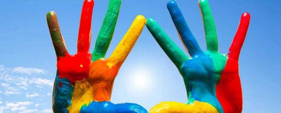 Two hands held up, covered in colorful paint.