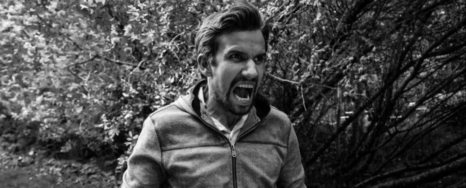 A black and white picture of a man screaming.