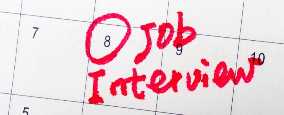 A calendar with a date circled and 'Job Interview' written.