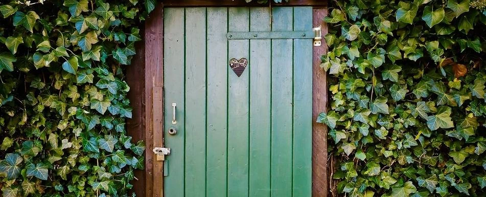 A door with a heart shaped window in the middle.