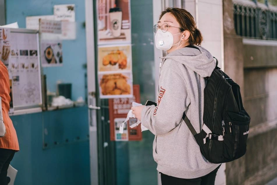 woman standing outside office in face mask