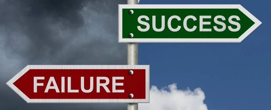 A signpost with one sign that says failure and the other says success.