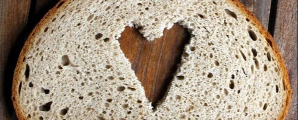 A slice of bread with a heart shape cut out of it.