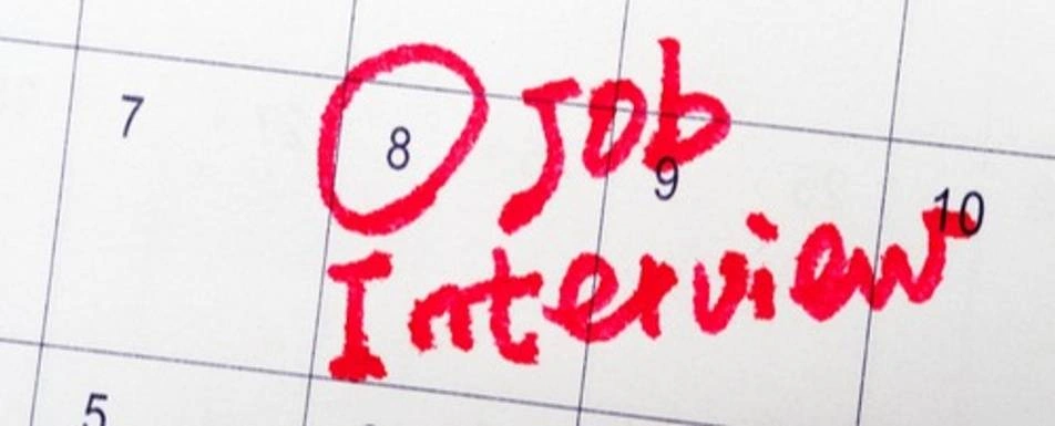 A calendar with a date circled in red marker. 'Job Interview' is written on the date.
