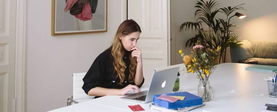 woman working from home looking at computer