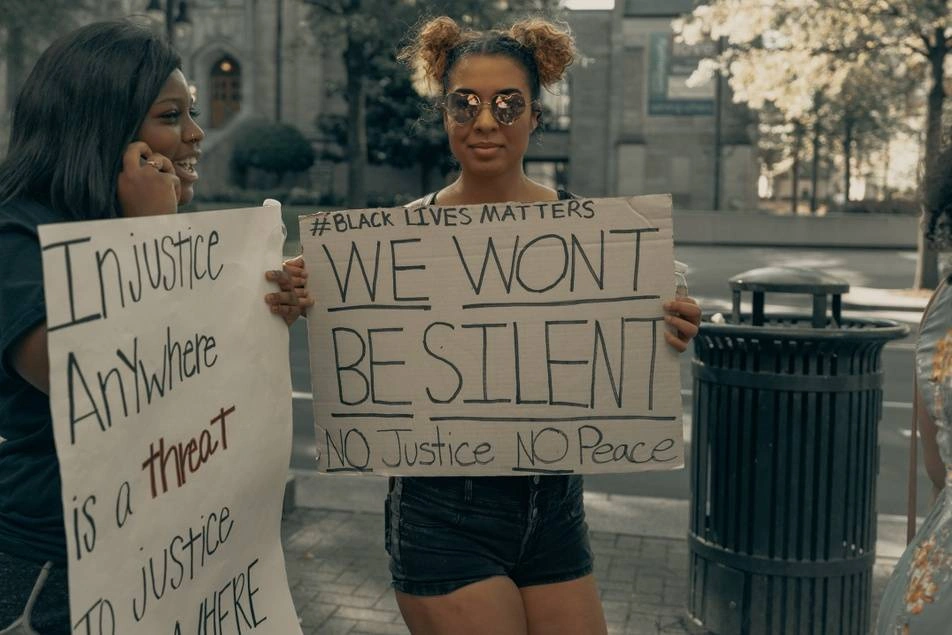 two women holding signs at Black Lives Matter protest