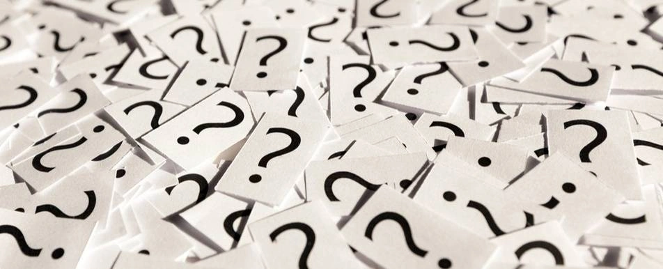 A pile of papers with question marks printed on each one.