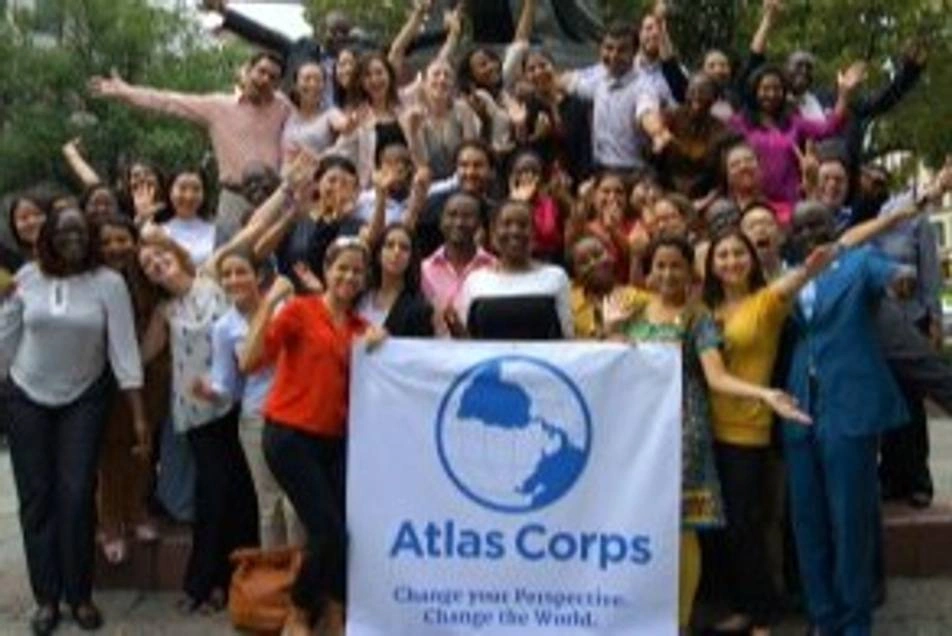 Varios voluntarios sosteniendo un cartel de Atlas Corps