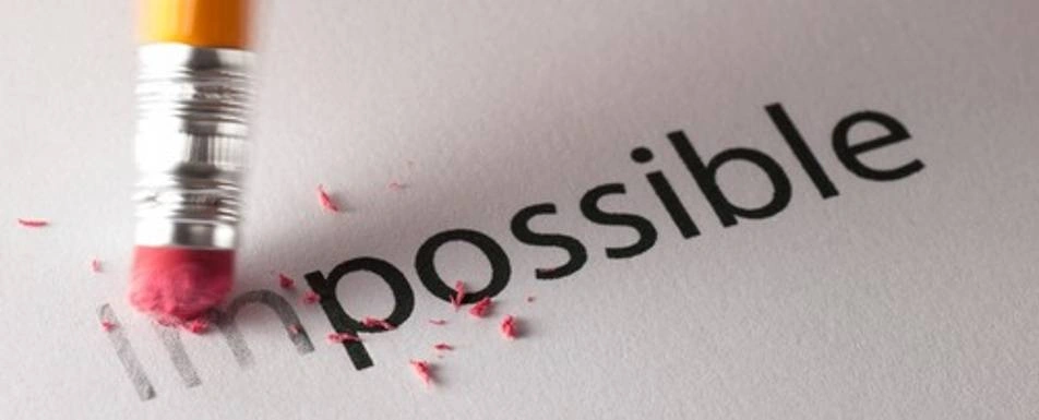 A pencil eraser erasing the word 'Impossible'.