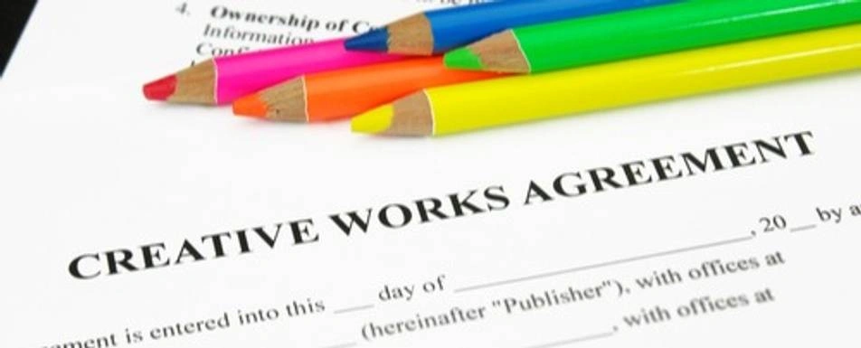 Crayon pencils and a Creative Works Agreement.