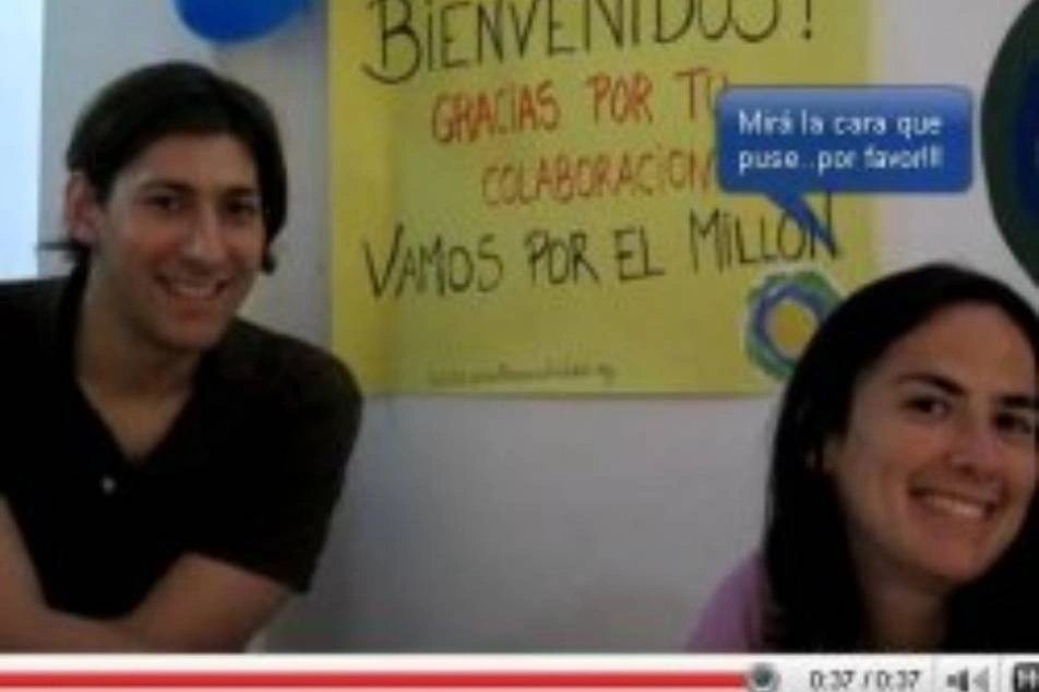 A screenshot of a video with two people smiling.