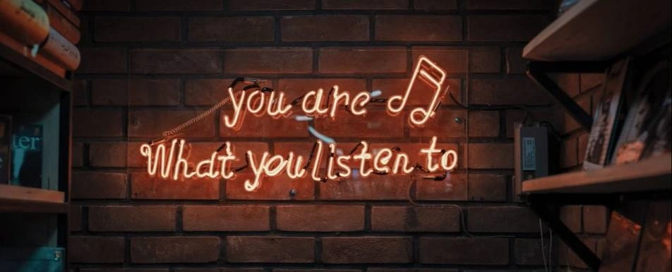 A light up sign that says, "You are what you listen to."