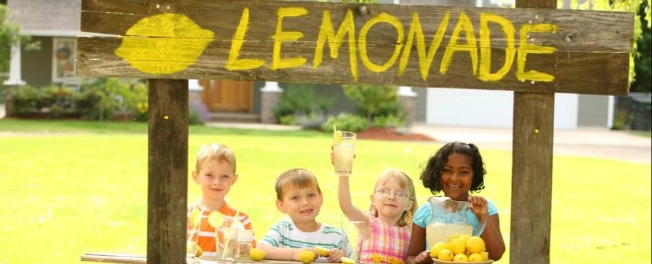 A group of children and their lemonade stand.