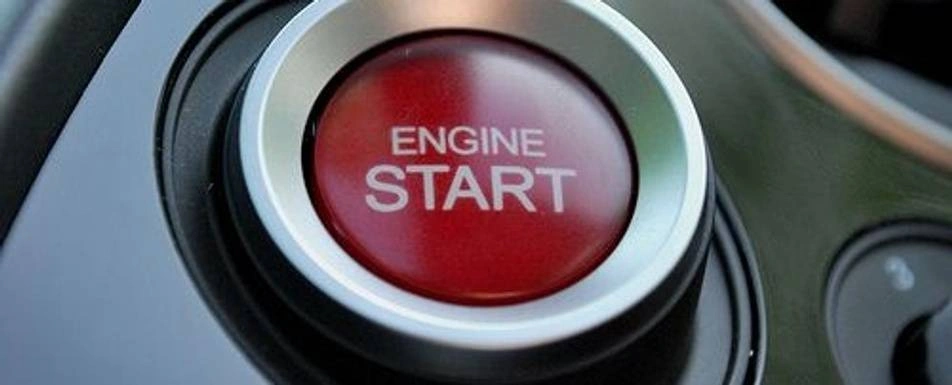 Close up of a button that says, "start engine."