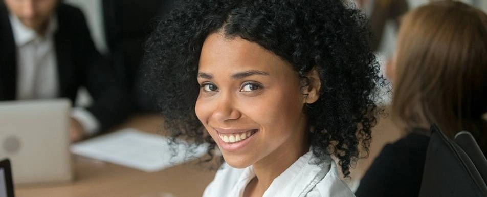 A Black woman smiling.