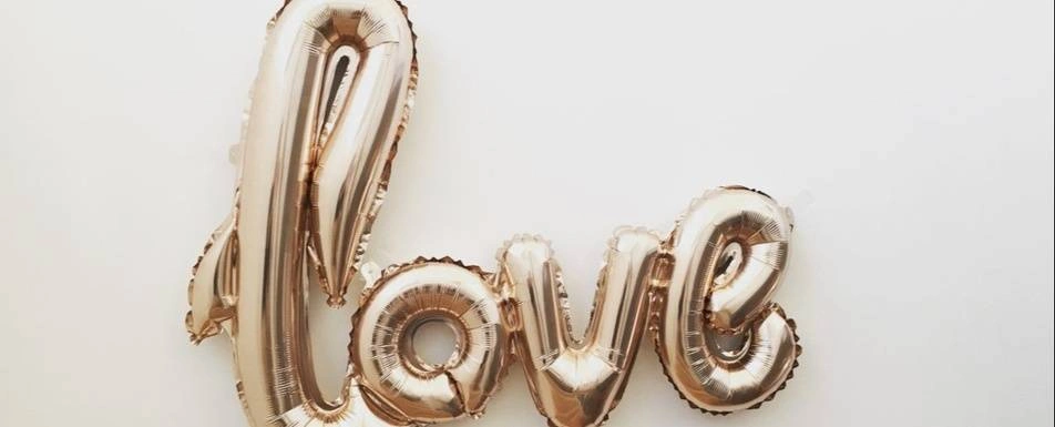 A balloon that says the word love.