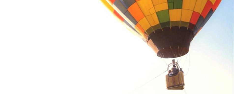 A photo of a hot air balloon in the air.