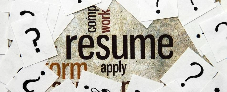 A graphic with hiring buzzwords and paper with question marks on them.