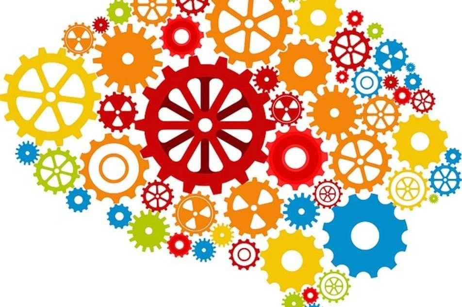 A graphic of colorful gears come together to form the shape of a brain.