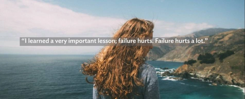 A woman looking out at the ocean under a quote about failure.