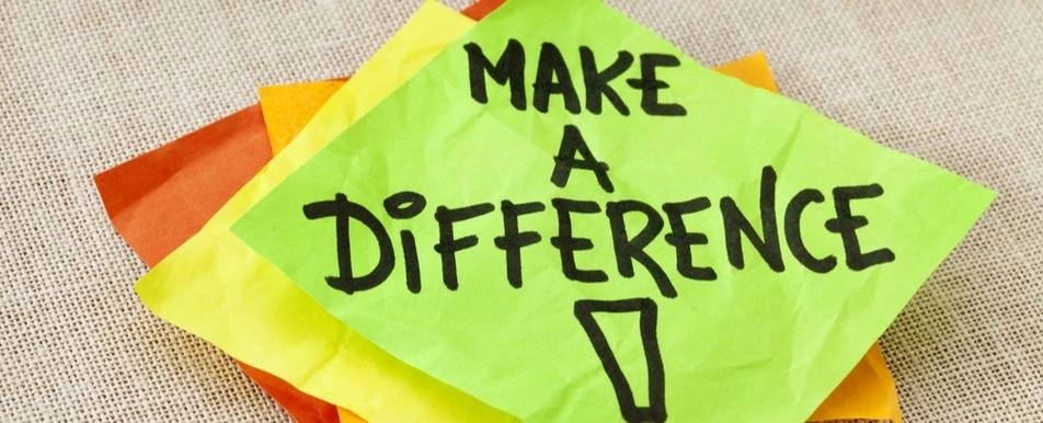 A rumpled up post it that says 'Make A Difference!'